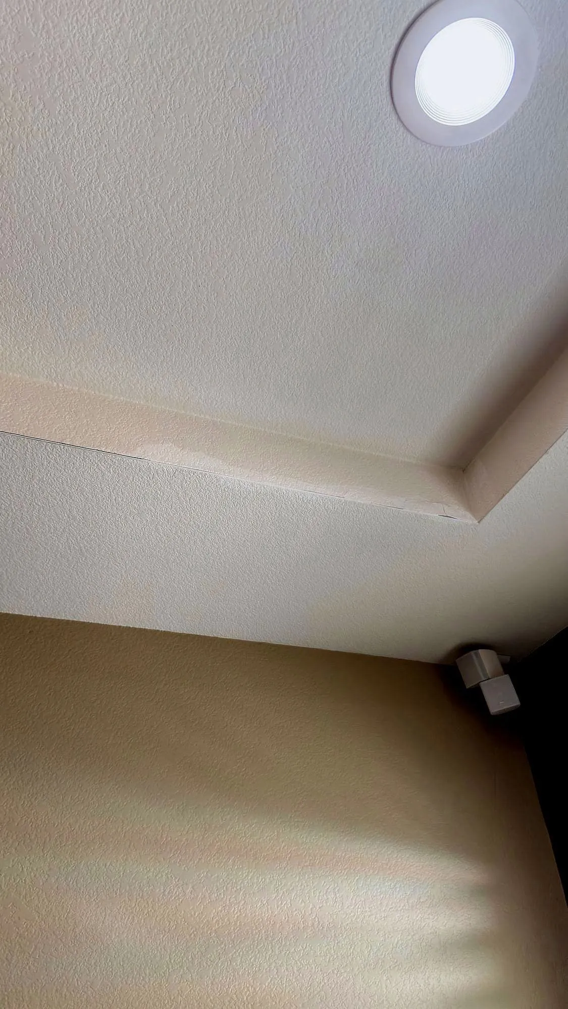 Ceiling stain where water had been getting in — patched and textured to match.