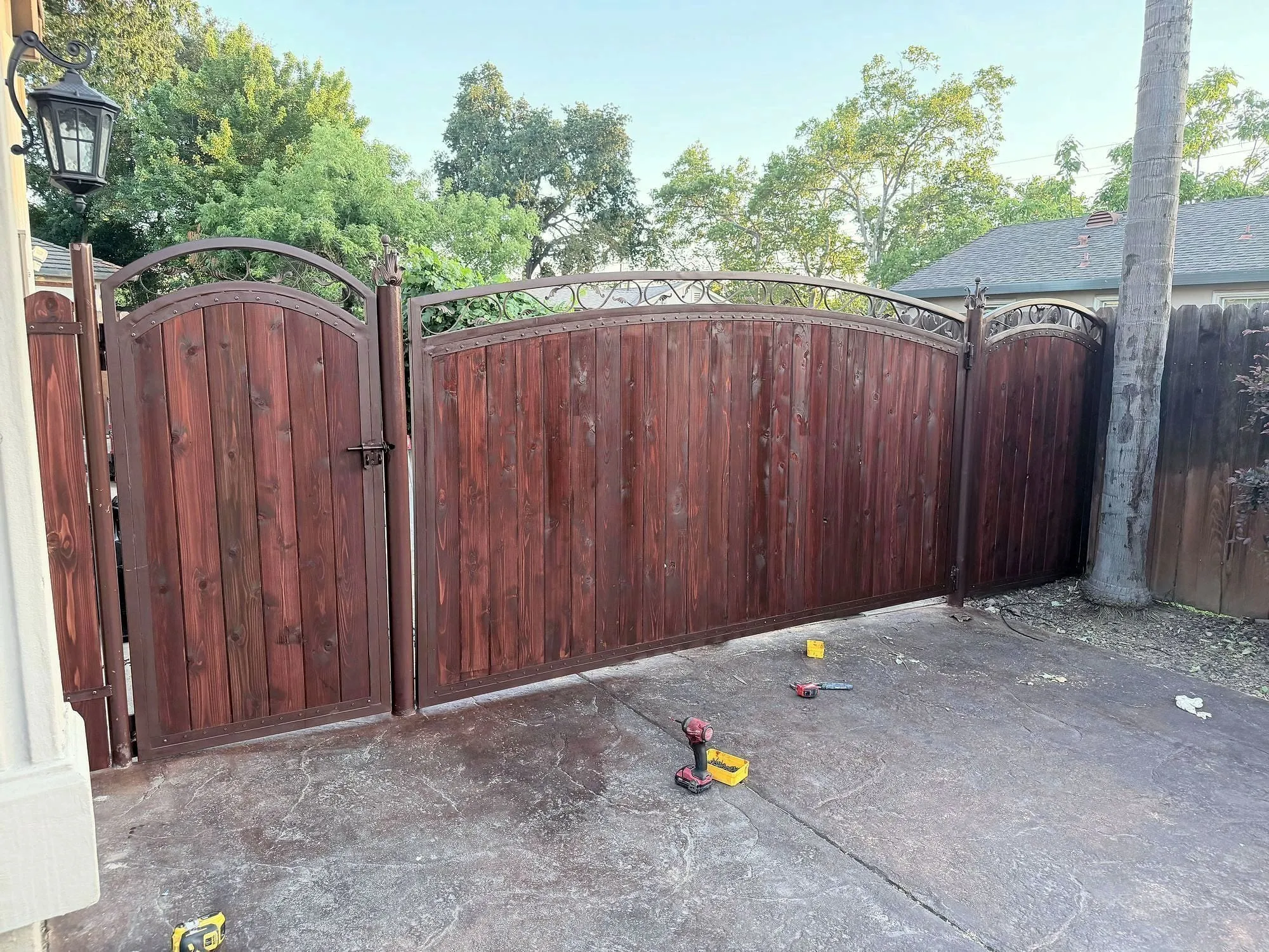 Tall double gates, stained and hung to swing clear.