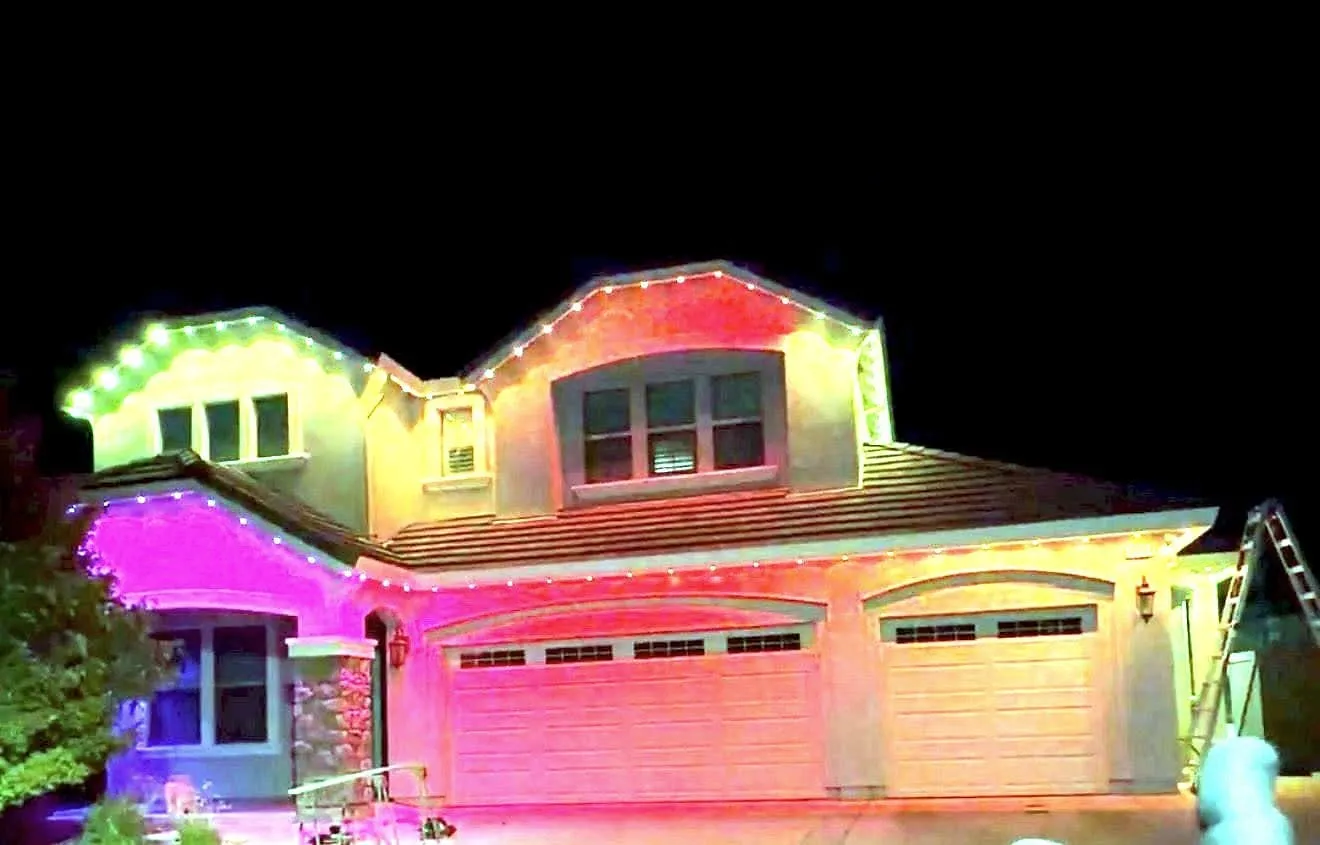 A Sacramento house lit for the holidays, roofline and eaves run in colour