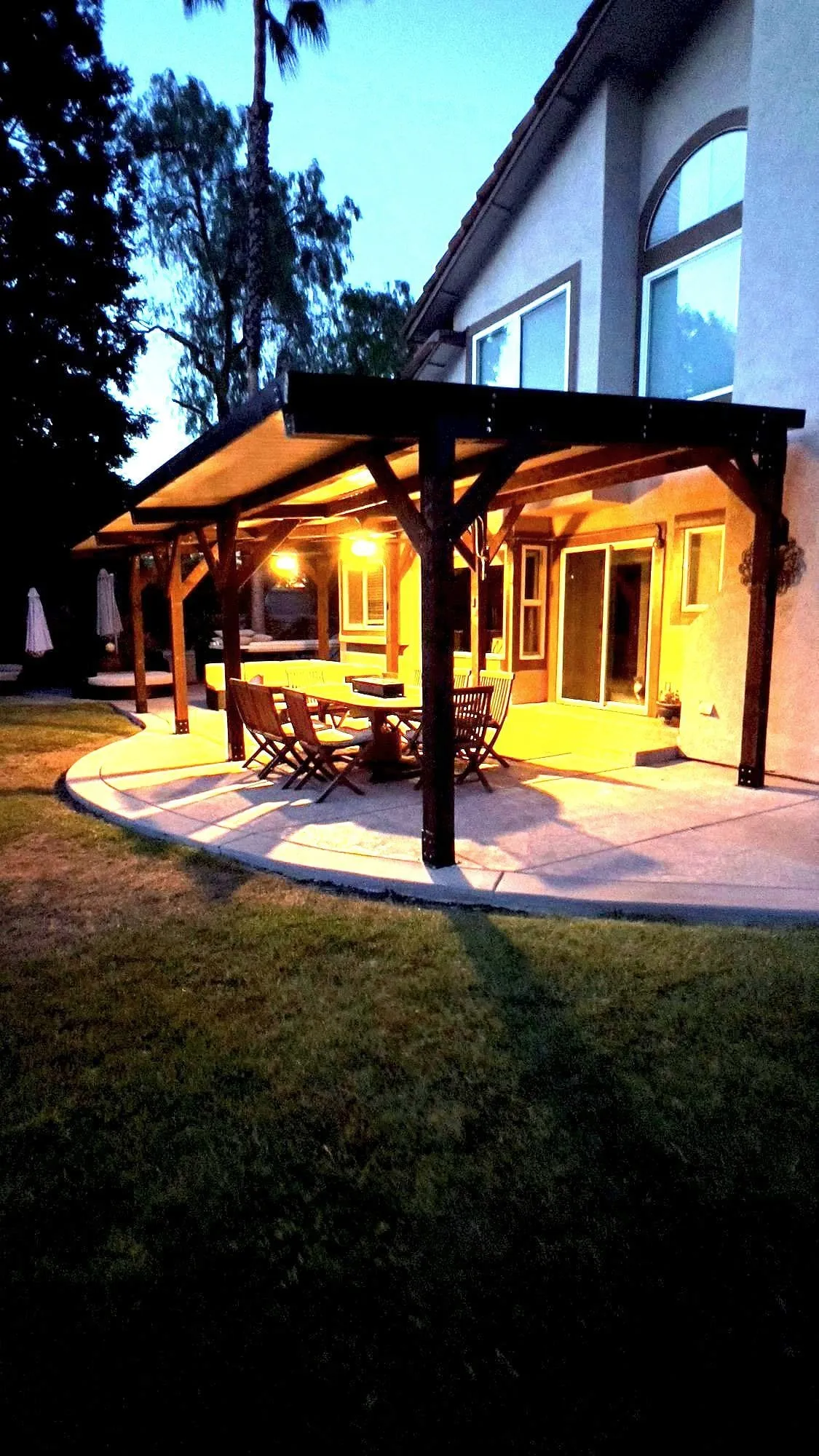 After — Backyard before and after a timber covered patio was built onto the back of the house