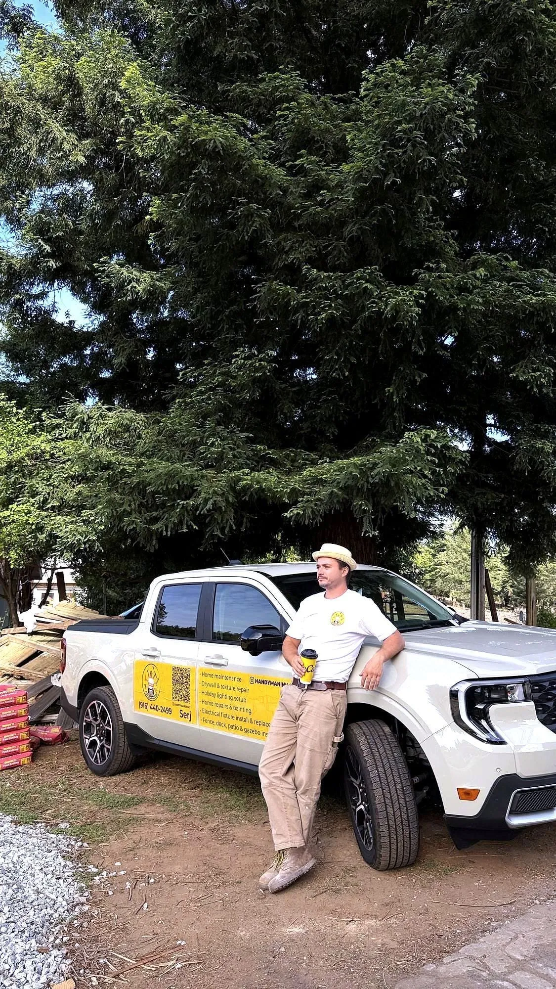 Serj beside his branded truck on a Sacramento job, phone number and services on the door