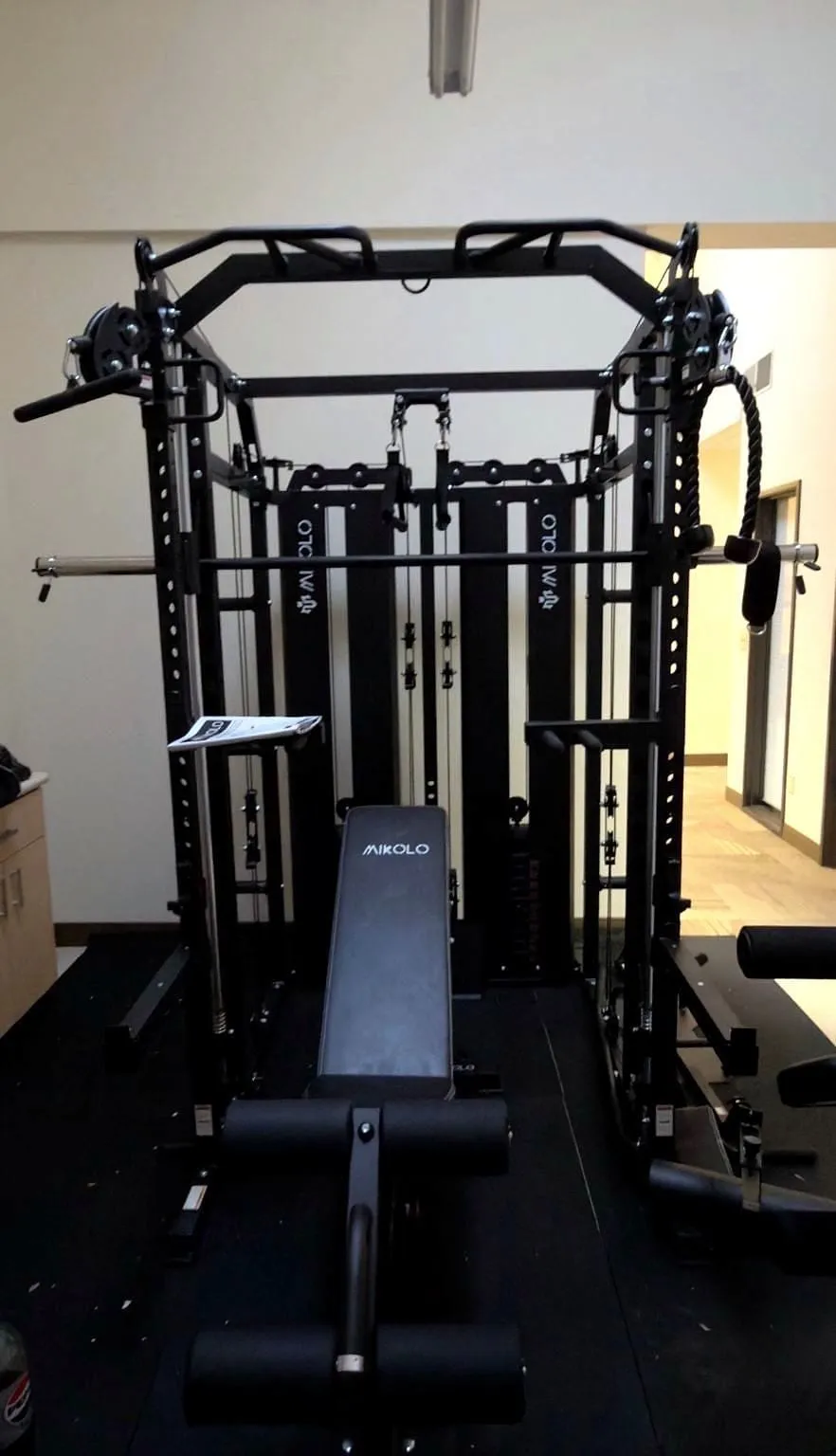 Assembled multi-station home gym rack installed in a converted garage